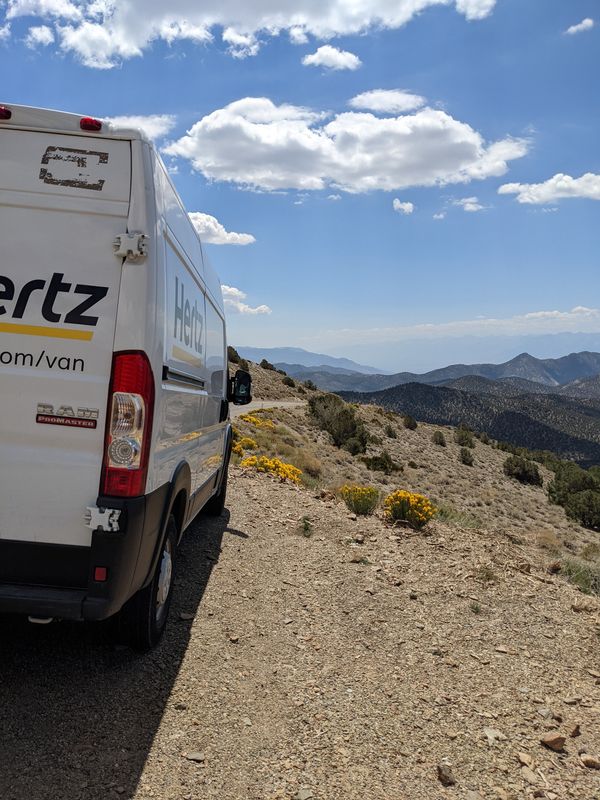 The rental van parked on a winding mountain road