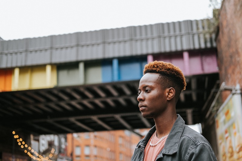 Person in front of rainbow colored building