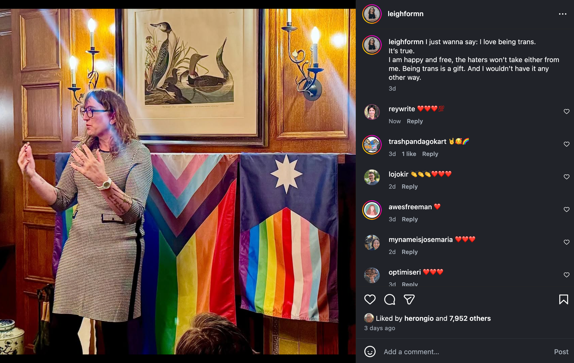 A screenshot from Instagram showing Rep. Leigh Finke, a white woman with blonde shoulder-length hair and glasses, speaking while standing in front of a progress Pride flag and two other flags